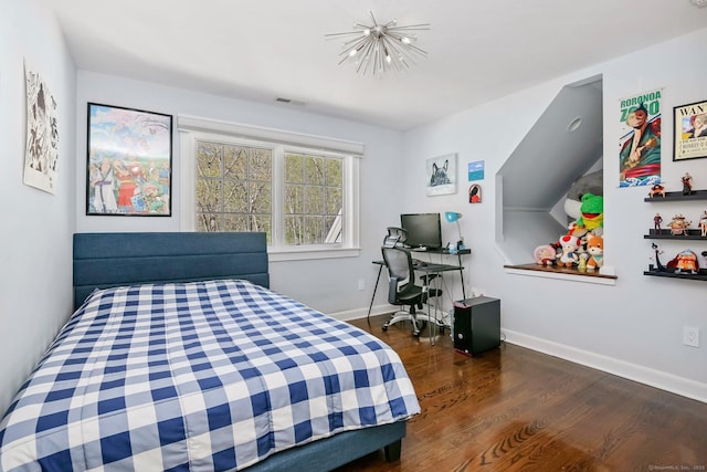 bedroom featuring wood finished floors and baseboards