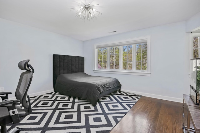 bedroom with baseboards and wood finished floors