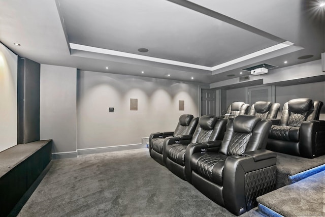 home theater room featuring a tray ceiling, carpet flooring, baseboards, and recessed lighting