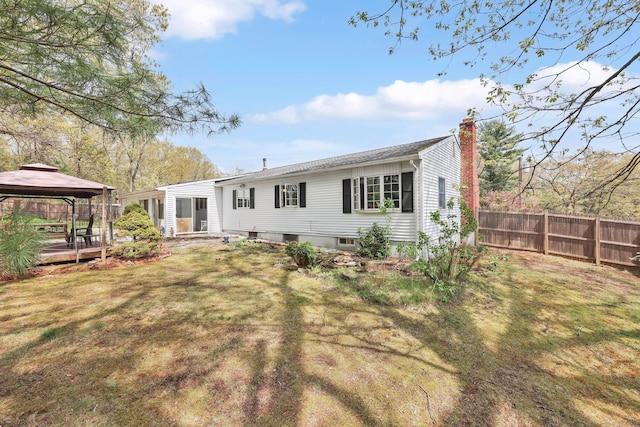 7 Sharren Ln, Enfield, CT 06082 - back of house featuring a gazebo, fence, a chimney, and a lawn