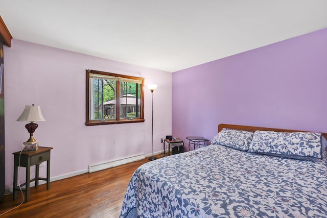 7 Sharren Ln, Enfield, CT 06082 - bedroom with a baseboard radiator, baseboards, and wood finished floors
