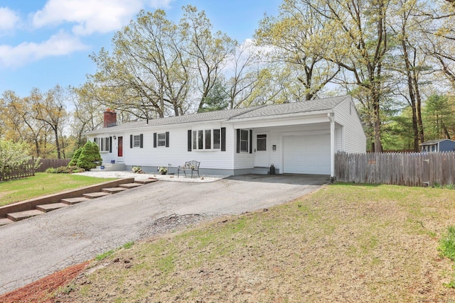 7 Sharren Ln, Enfield, CT 06082 - view of front facade with fence, an attached garage, driveway, a front lawn, and a chimney