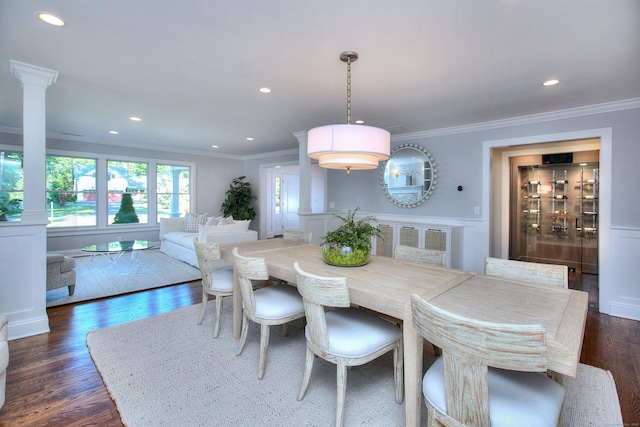 dining area featuring crown molding, dark wood-type flooring, decorative columns, and recessed lighting