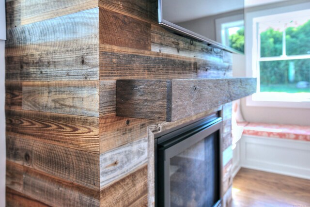 interior details featuring wine cooler and wood finished floors