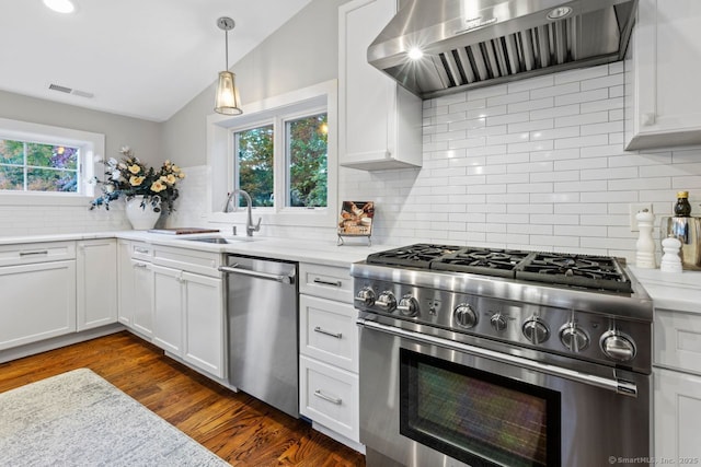 kitchen with stainless steel appliances, ventilation hood, white cabinets, visible vents, and decorative backsplash