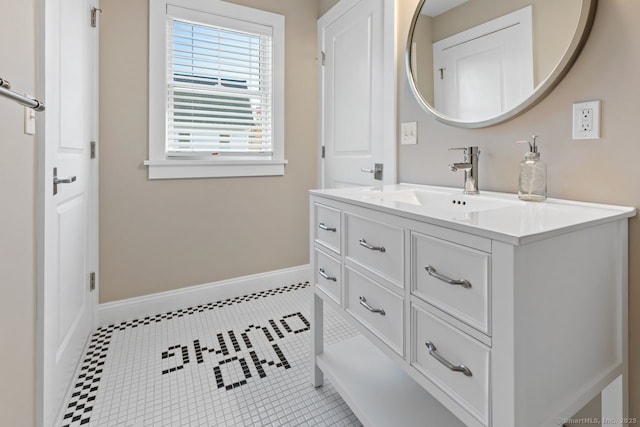 bathroom with baseboards, vanity, and tile patterned flooring