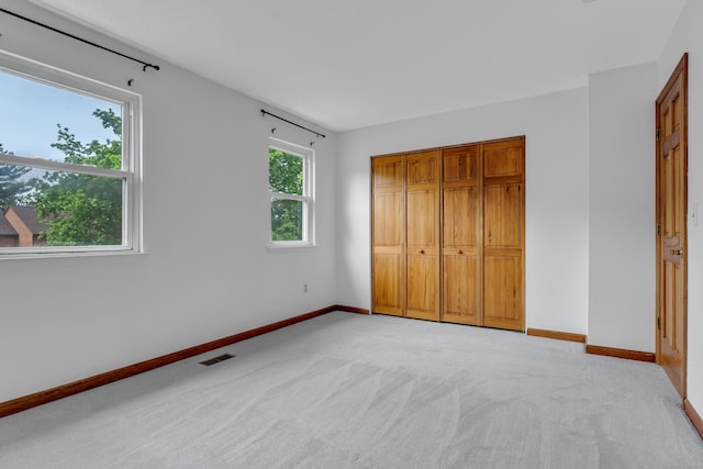 53 Cedar Knolls Dr Unit 53, Branford, CT 06405 - unfurnished bedroom with light carpet, baseboards, and a closet