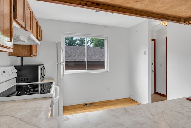 53 Cedar Knolls Dr Unit 53, Branford, CT 06405 - kitchen featuring electric range, under cabinet range hood, brown cabinetry, light wood-style floors, and stainless steel microwave