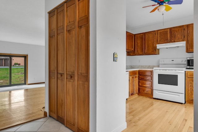 53 Cedar Knolls Dr Unit 53, Branford, CT 06405 - kitchen with electric range, under cabinet range hood, light countertops, a ceiling fan, and light wood-style floors
