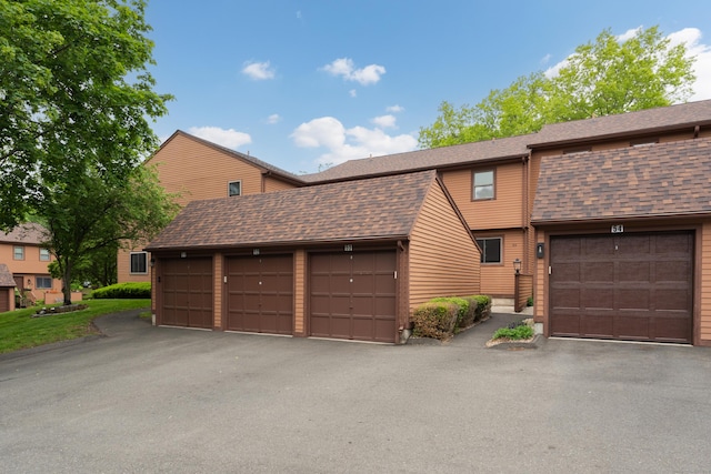 53 Cedar Knolls Dr Unit 53, Branford, CT 06405 - view of front of property featuring community garages and a shingled roof