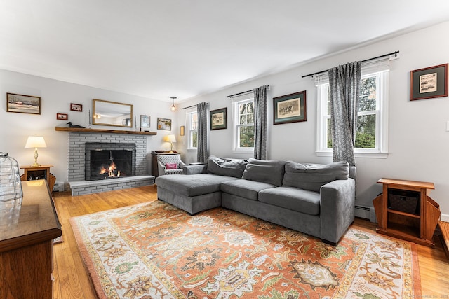 16 Howes Ln, Redding, CT 06896 - living area with a brick fireplace, light wood finished floors, and baseboard heating