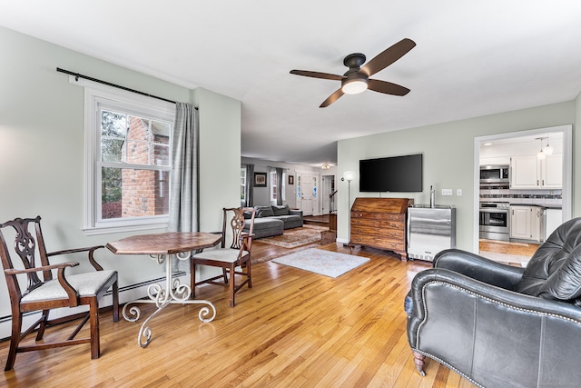 16 Howes Ln, Redding, CT 06896 - living room with ceiling fan, light wood-type flooring, wine cooler, and a baseboard heating unit