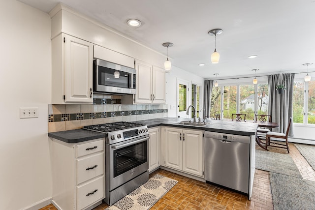 16 Howes Ln, Redding, CT 06896 - kitchen with appliances with stainless steel finishes, a peninsula, dark countertops, healthy amount of natural light, and recessed lighting