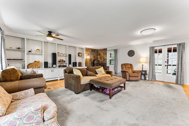 16 Howes Ln, Redding, CT 06896 - living room with a baseboard radiator, light wood-style flooring, french doors, a ceiling fan, and built in shelves