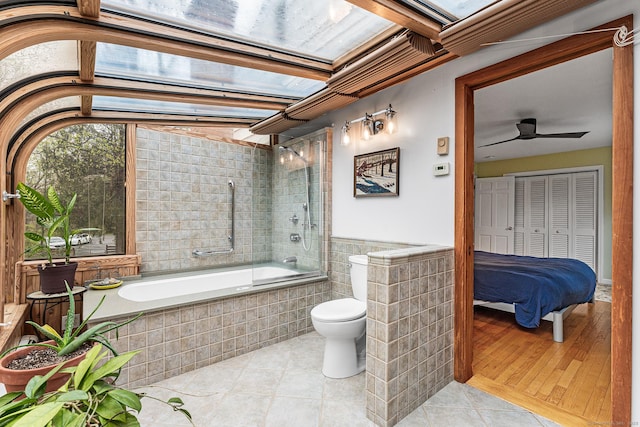 16 Howes Ln, Redding, CT 06896 - full bathroom featuring tile patterned floors, tiled shower / bath, ceiling fan, and tile walls
