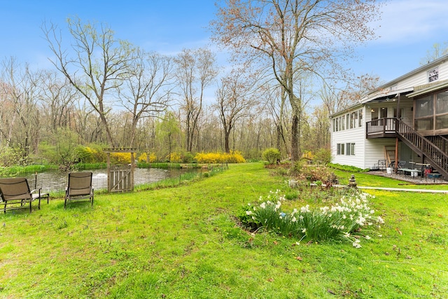 16 Howes Ln, Redding, CT 06896 - view of green lawn with stairway, a sunroom, and a deck