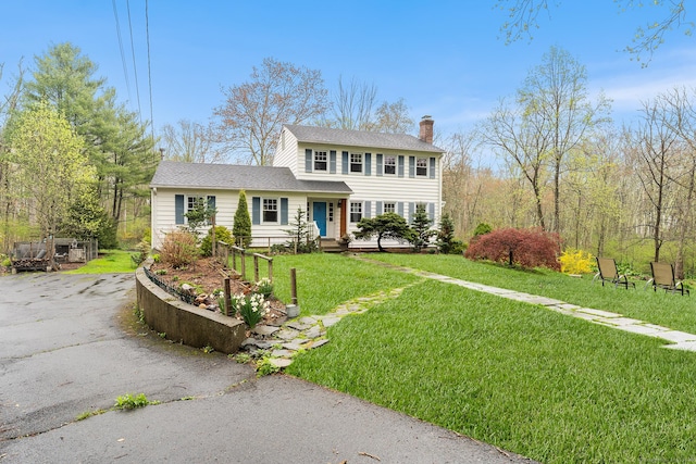 16 Howes Ln, Redding, CT 06896 - view of front of house featuring a chimney, a front yard, and roof with shingles
