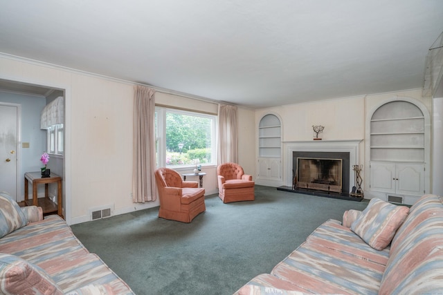 955 N Main St, West Hartford, CT 06117 - living room featuring carpet floors, a fireplace with raised hearth, built in shelves, and crown molding