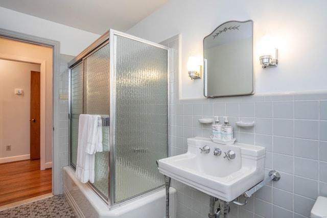 955 N Main St, West Hartford, CT 06117 - full bathroom with bath / shower combo with glass door, tile walls, and a sink