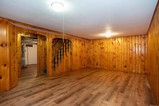 955 N Main St, West Hartford, CT 06117 - basement with stairway, arched walkways, wooden walls, water heater, and wood finished floors