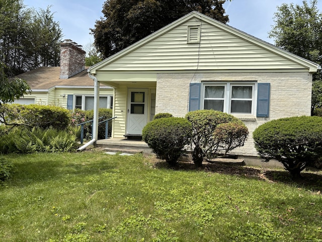 955 N Main St, West Hartford, CT 06117 - bungalow-style house featuring a front yard and a chimney