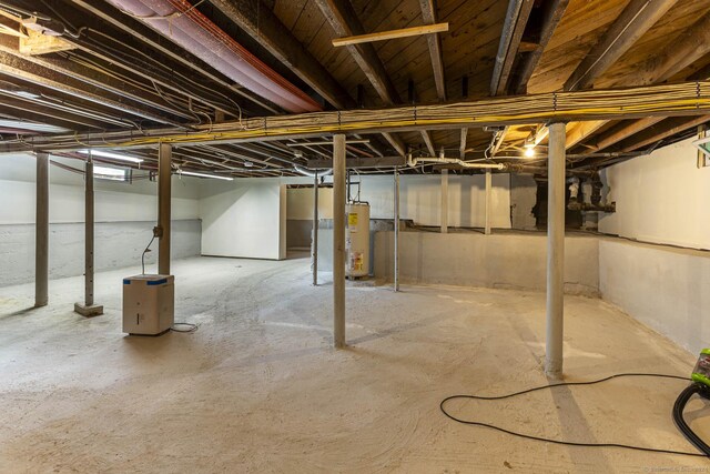 unfinished basement with electric water heater