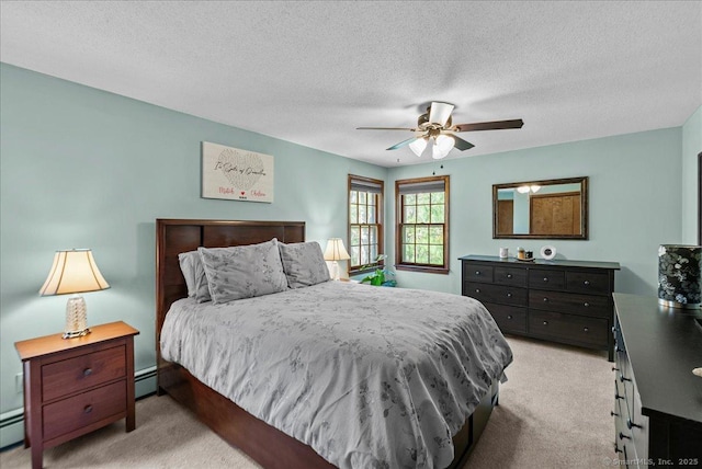 bedroom with ceiling fan, baseboard heating, a textured ceiling, and light colored carpet