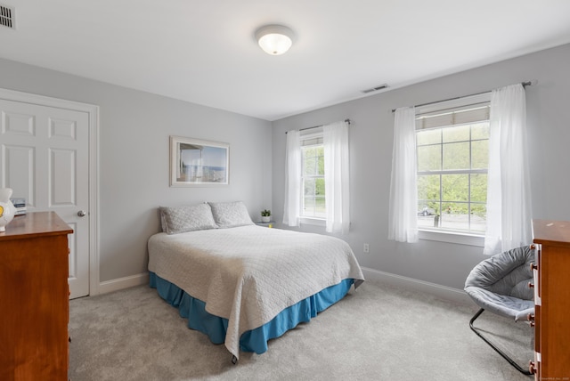 bedroom featuring carpet flooring, visible vents, and baseboards