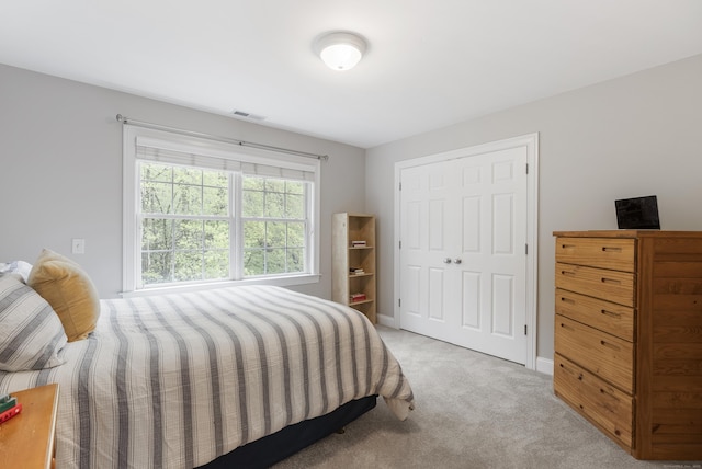 bedroom featuring light carpet and visible vents