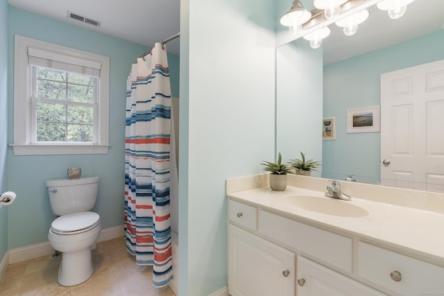bathroom with toilet, vanity, visible vents, tile patterned flooring, and baseboards