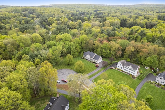 birds eye view of property with a view of trees
