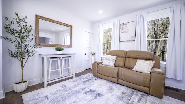 living area with recessed lighting, baseboards, visible vents, and wood finished floors