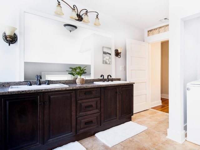 full bathroom featuring double vanity, a sink, and tile patterned flooring