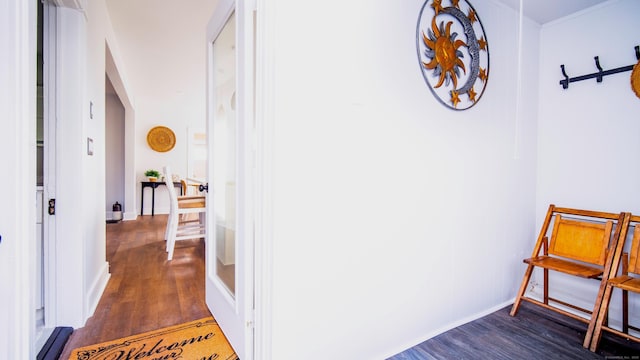 hall featuring dark wood-type flooring and baseboards