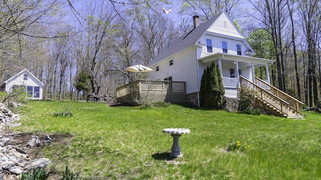 view of yard featuring covered porch and stairway