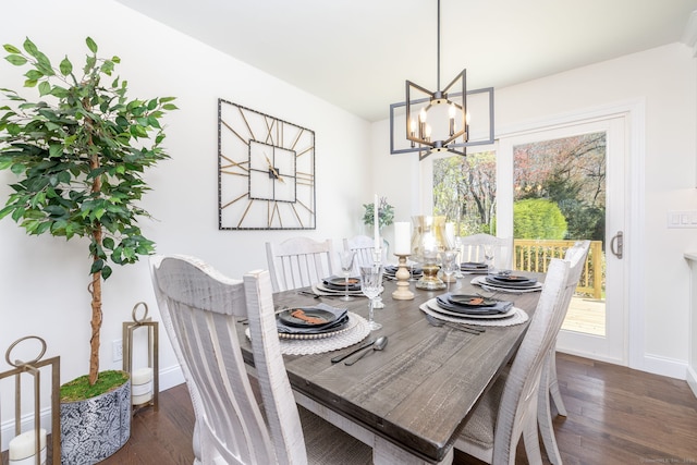 dining space featuring dark wood-style flooring, baseboards, and an inviting chandelier