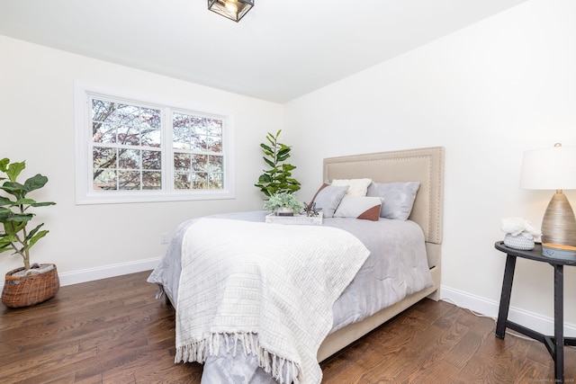 bedroom featuring baseboards and wood finished floors