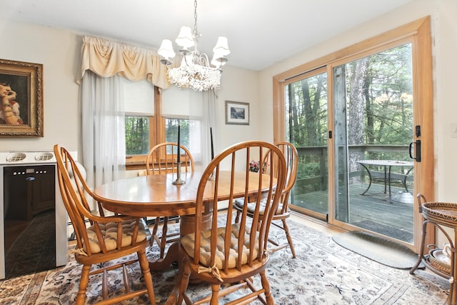 dining space featuring a chandelier and plenty of natural light