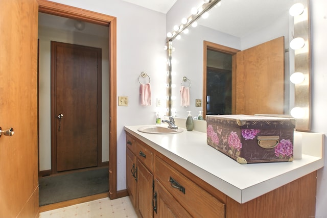 bathroom with tile patterned floors and vanity