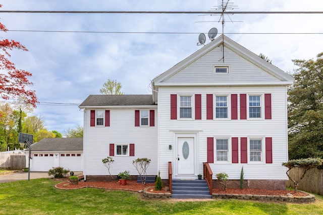 neoclassical / greek revival house with fence, driveway, and a front lawn