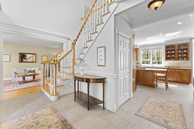 staircase featuring crown molding, recessed lighting, baseboards, and tile patterned flooring