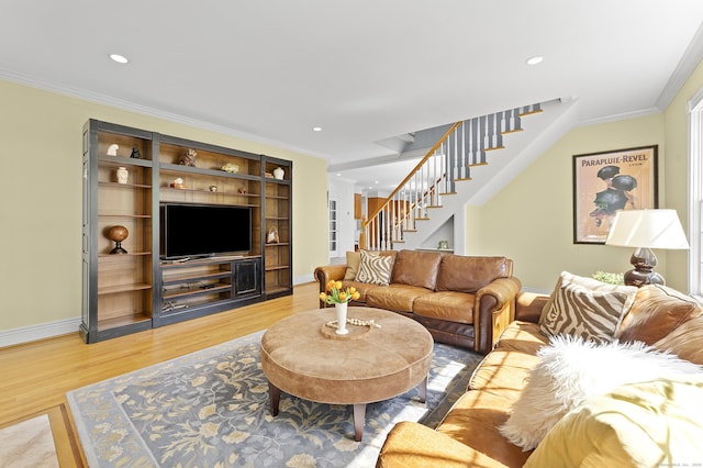 living area with stairs, crown molding, baseboards, and light wood finished floors