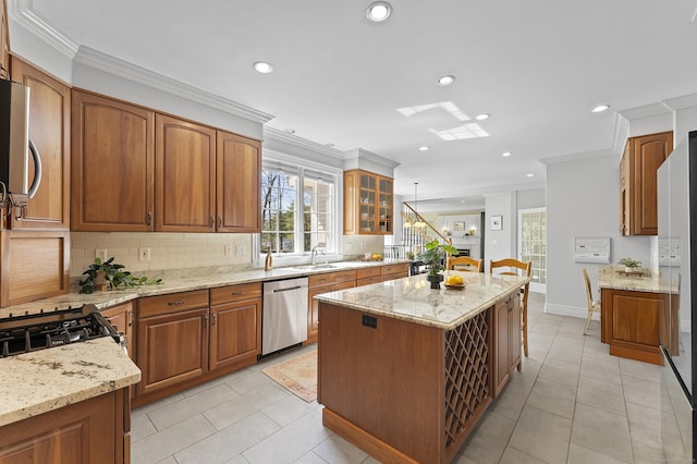 kitchen with decorative backsplash, a kitchen island, stainless steel dishwasher, light stone counters, and recessed lighting