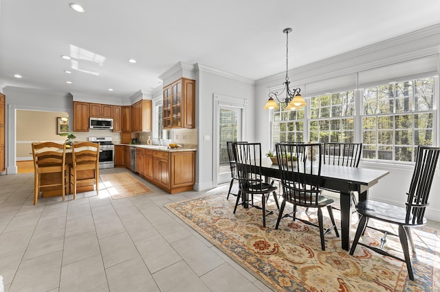 dining room with light tile patterned floors, baseboards, and crown molding