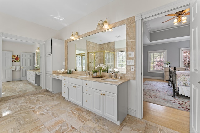 full bath featuring crown molding, vanity, a ceiling fan, baseboards, and a shower stall