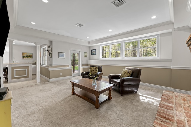 carpeted living room with crown molding, decorative columns, and visible vents