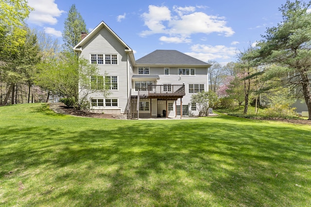rear view of property featuring a wooden deck, a yard, and a chimney