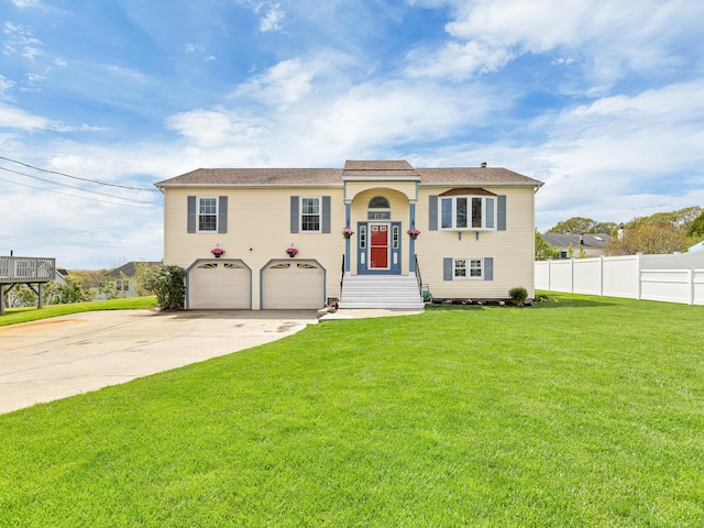 29 Washington Dr, Groton, CT 06340 - view of front facade featuring fence, an attached garage, driveway, and a front yard