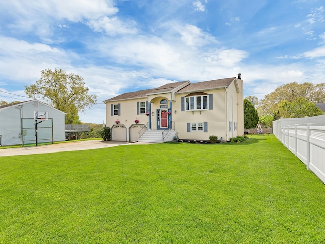 29 Washington Dr, Groton, CT 06340 - split foyer home with a garage, a chimney, fence, concrete driveway, and a front yard