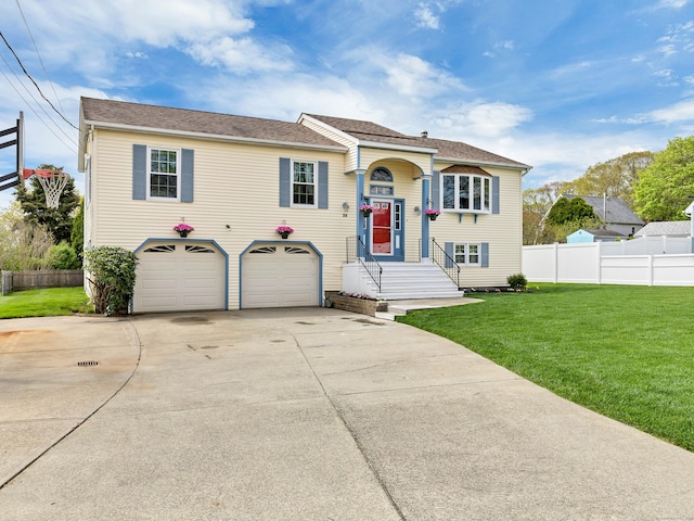 29 Washington Dr, Groton, CT 06340 - split foyer home featuring a front lawn, driveway, a garage, and fence